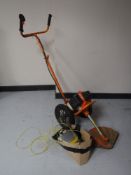A Sherpa petrol grass strimmer with accessories