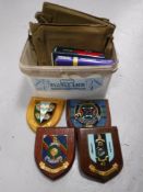 A box of five military coats of arms plaques together with two insignia books and three military