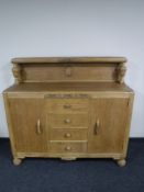 An early 20th century carved oak buffet backed sideboard