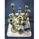 A tray of brass candlesticks and John Linwood antique spit