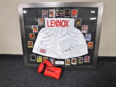 A framed pair of boxing shorts signed by Lennox Lewis,