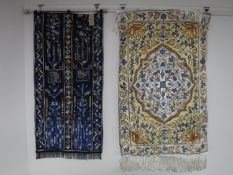 Two fringed Eastern wall hangings