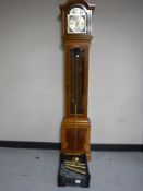 An inlaid yew wood Thomas Byrne granddaughter clock with pendulum and weights