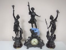 A three piece French spelter clock garniture