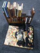 A miniature book rack containing assorted miniature volumes, a hand painted ebonised letter rack,