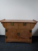 A contemporary oriental style sideboard fitted two drawers