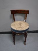 An antique mahogany dressing table chair