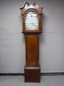 An oak eight day longcase clock with pendulum and weights
