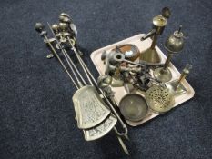 A pair of antique brass fire dogs, two brass shovels, brass fire poker and tongs,