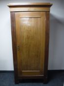 An early 20th century single door mahogany wardrobe
