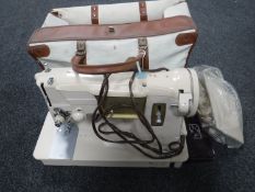 A cased Singer electric sewing machine