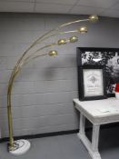 A brass four branch reading lamp on circular marble base