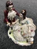 A Dresden porcelain figure group of a lady and gentleman in 18th century dress