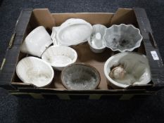 A box containing twelve antique glazed pottery jelly moulds