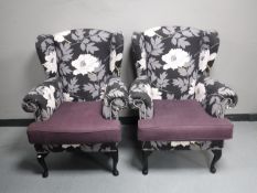 A pair of wing back armchairs in a floral fabric