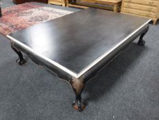 A painted over sized coffee table on claw and ball feet