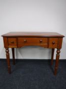A reproduction three drawer hall table