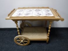 A blond oak tiled topped serving trolley
