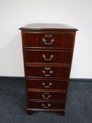 A mahogany three drawer filing chest inset green leather panel