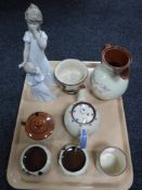 A tray of two Nao figures and seven pieces of tourist pottery
