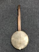 A late 19th century English open back five string banjo,