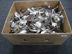 A box of assorted flat ware and utensils