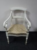 An early 20th century painted scroll arm armchair