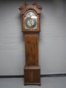 A continental oak longcase clock with pendulum and weights