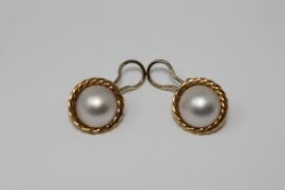 A pair of 18ct gold mabe pearl earrings