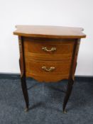An inlaid mahogany shaped bedside chest with ormolu mounts
