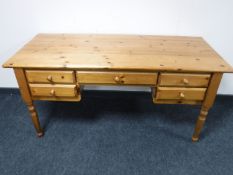 A pine writing desk fitted five drawers