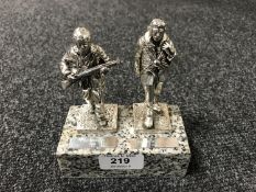 A pair of silver plated military figures on granite plinth,