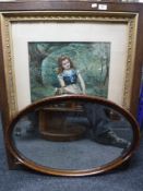 An Edwardian oak and gilt framed print - girl picking flowers and an oval framed mirror