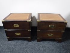 A pair of two drawer ship's style chests with brass mounts and inset leather panel