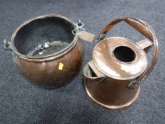 An antique copper cauldron and a watering can