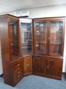 An inlaid mahogany triple section corner display cabinet