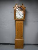An oak eight day longcase clock with painted dial signed W.