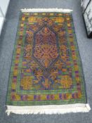 An Iranian rug on blue and green ground,