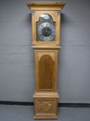 An oak longcase clock with pendulum and weights
