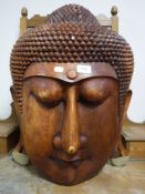 A large wooden Buddha head