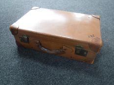 A vintage leather luggage case together with an early 20th century frameless bevelled mirror