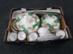 A box containing a Sandringham china tea and dinner service together with a Royal Stafford Roses to