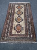 A fringed Persian rug on blue ground