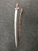 An Eastern leather handled sword in scabbard