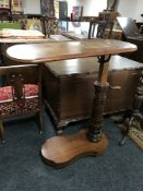 A Victorian mahogany adjustable bed table