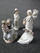 Four Nao figures to include mother with child, hiker holding a bird,