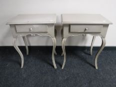 A pair of contemporary French style bedside tables fitted drawers (leg damaged)