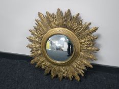 An early twentieth century circular convex mirror in a gilt sunburst frame