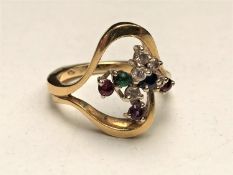 An 18ct gold multi stone ring, of wrythen form with diamonds, sapphire, emerald, amethyst,