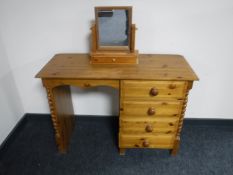 A pine four drawer dressing table with mirror